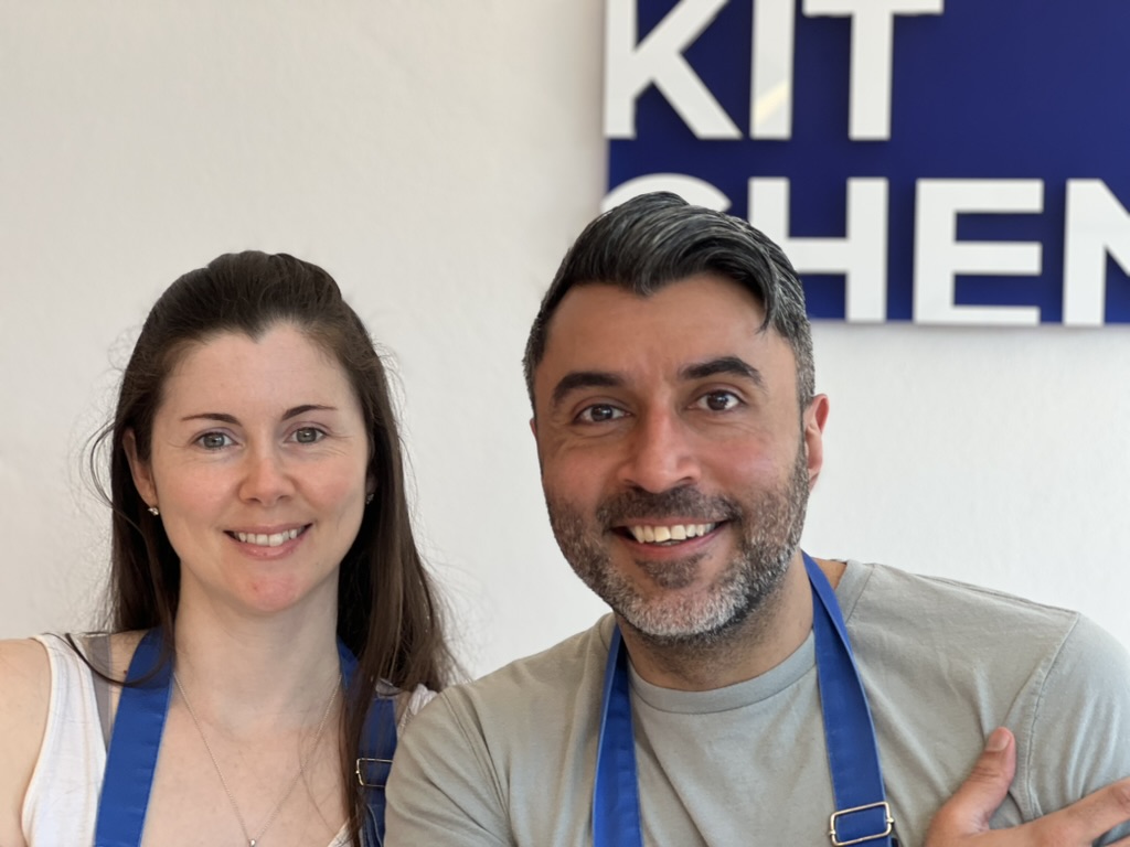 Aisling and Farouk in cooking aprons